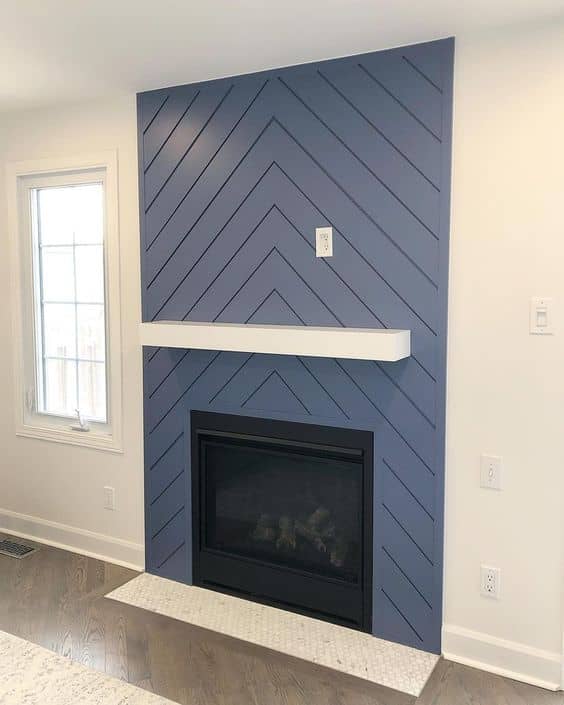 herringbone pattern shiplap fireplace design with white mantel