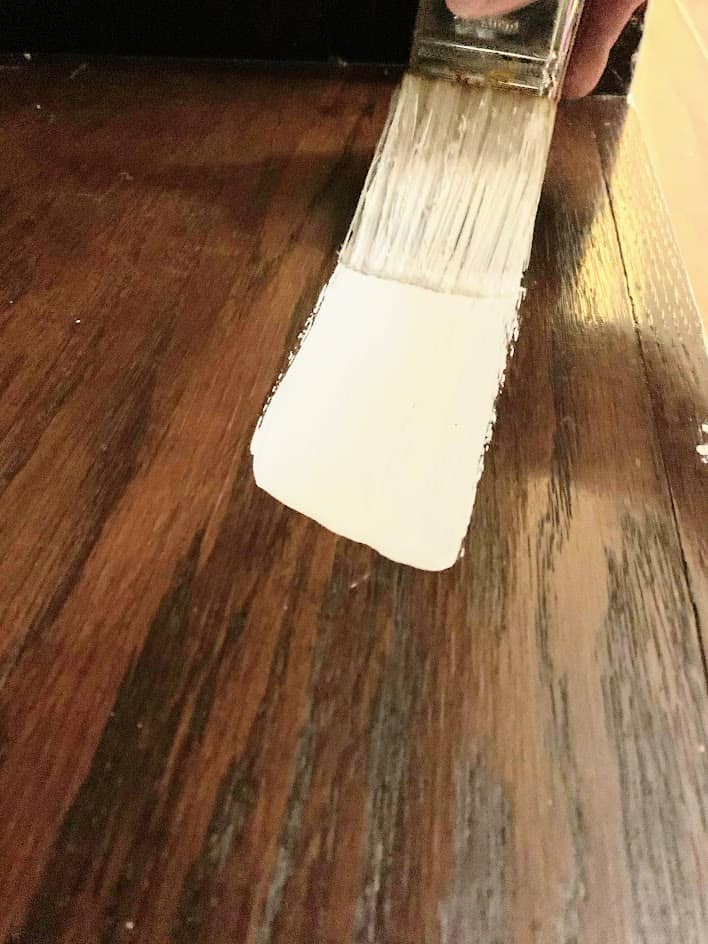 Paint brush on wood cabinet